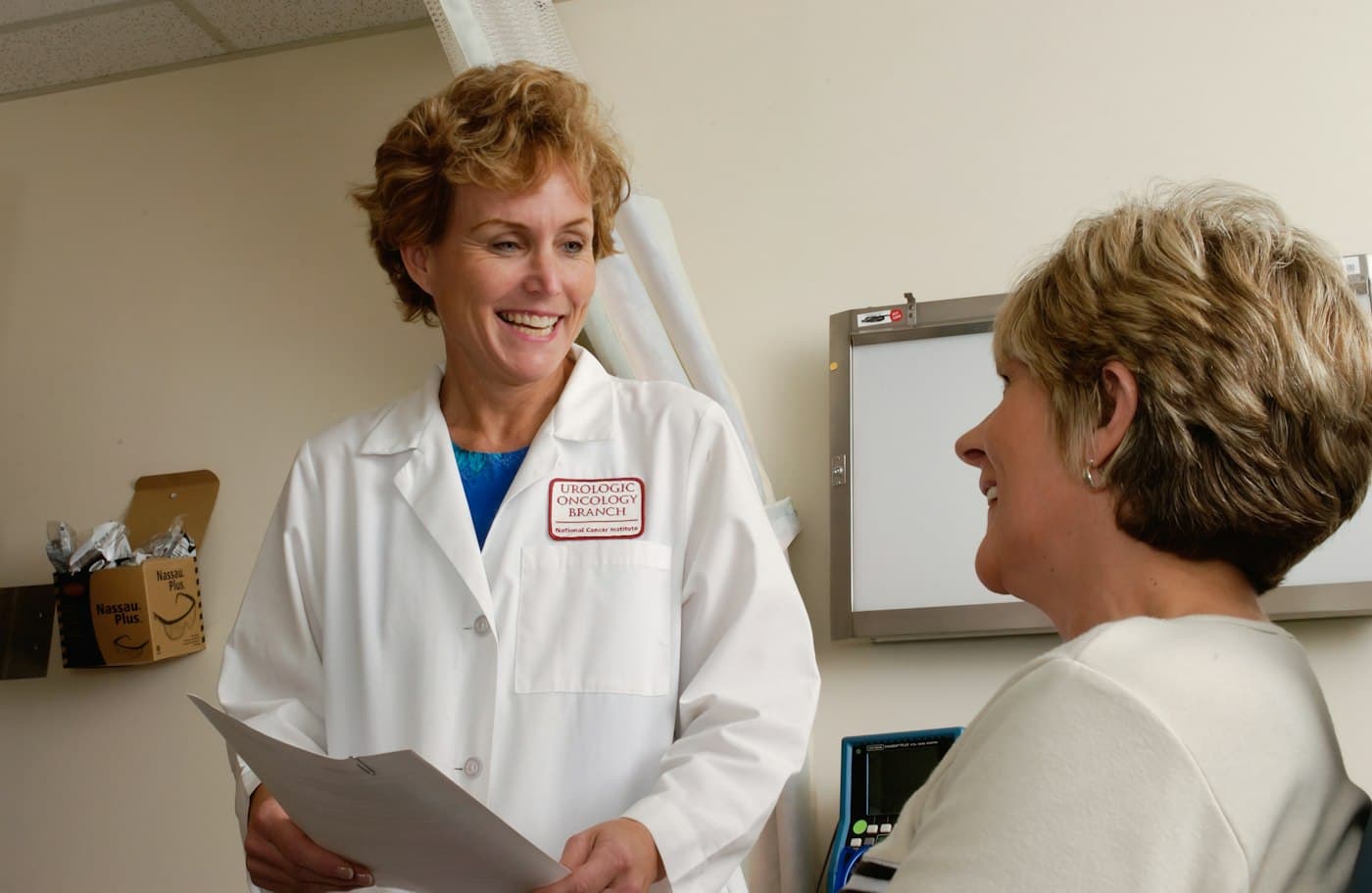 A practice manager at the front desk of a clinic